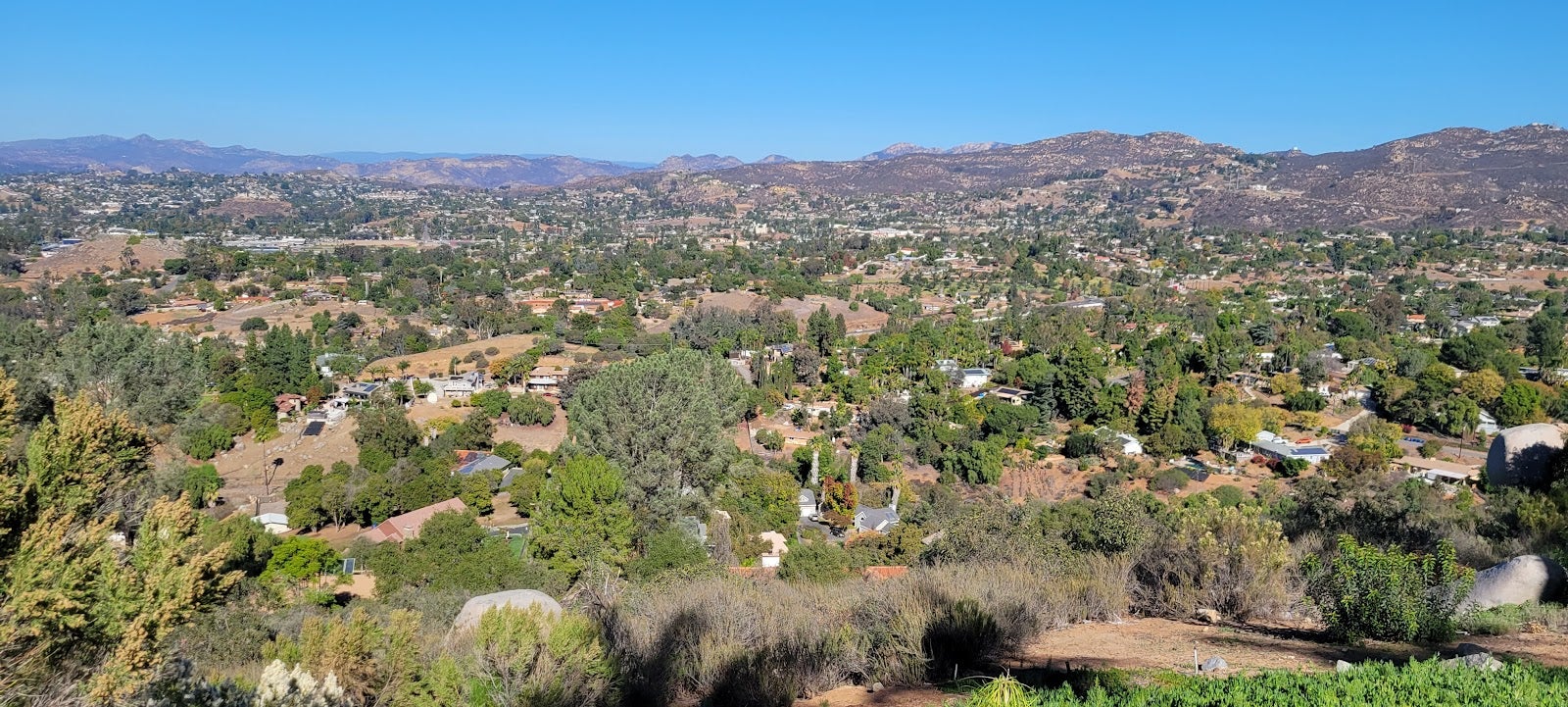 An aerial view of El Cajon showing clusters of houses surrounded by scattered trees.