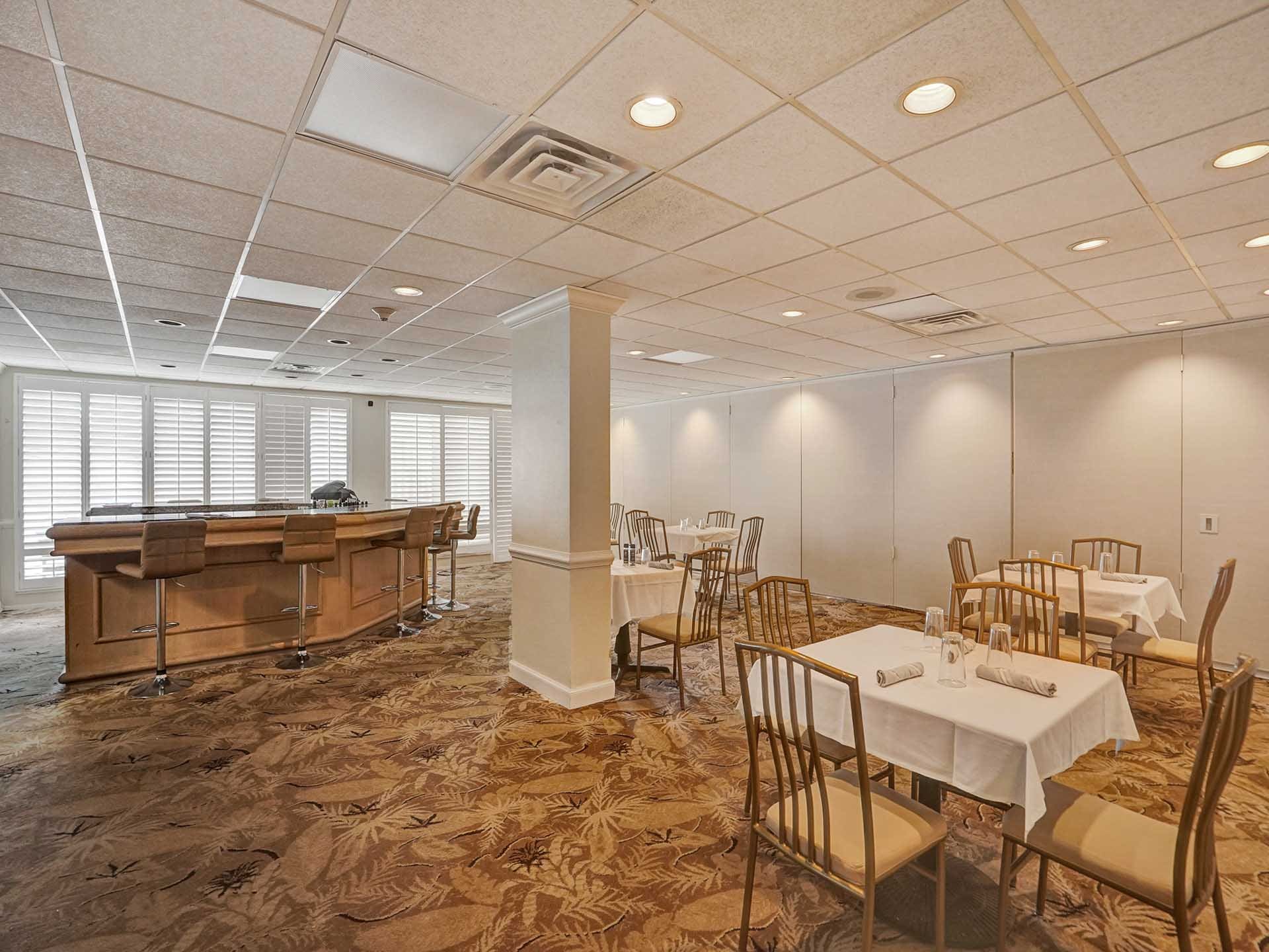 Exclusive resident clubroom, dining area, and bar space at Point of Americas on S Ocean Lane in Fort Lauderdale.