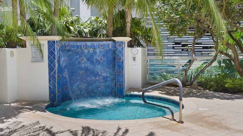 Relax by the spa and waterfall feature at 347 N New River Dr E, a premier luxury waterfront building listed by Prestige Waterfront Realty.