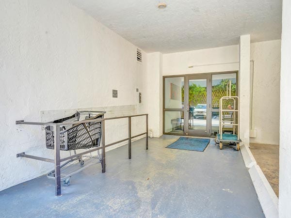 The convenient covered entrance and loading zone at East Point Towers, complete with resident carts for easy transport of groceries and belongings.