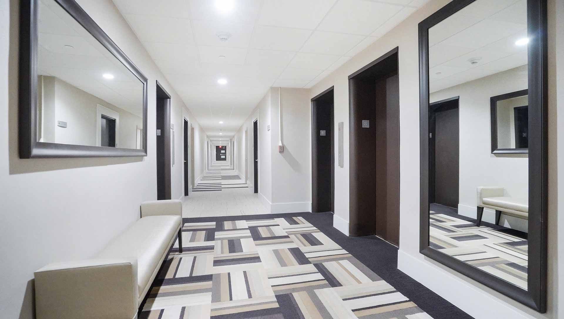 Step into the elegantly updated elevator lobby at Coral Ridge Towers East, reflecting the pristine standard of living available in Fort Lauderdale. This beautifully modernized common space features crisp neutral tones, chic seating, and bright lighting, p