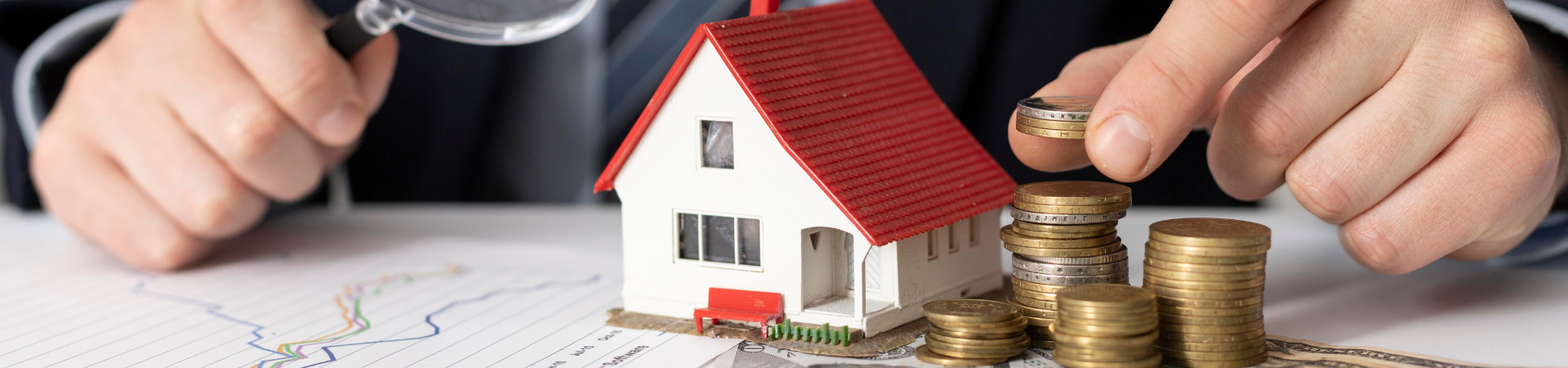 Toy house with change stacked nearby