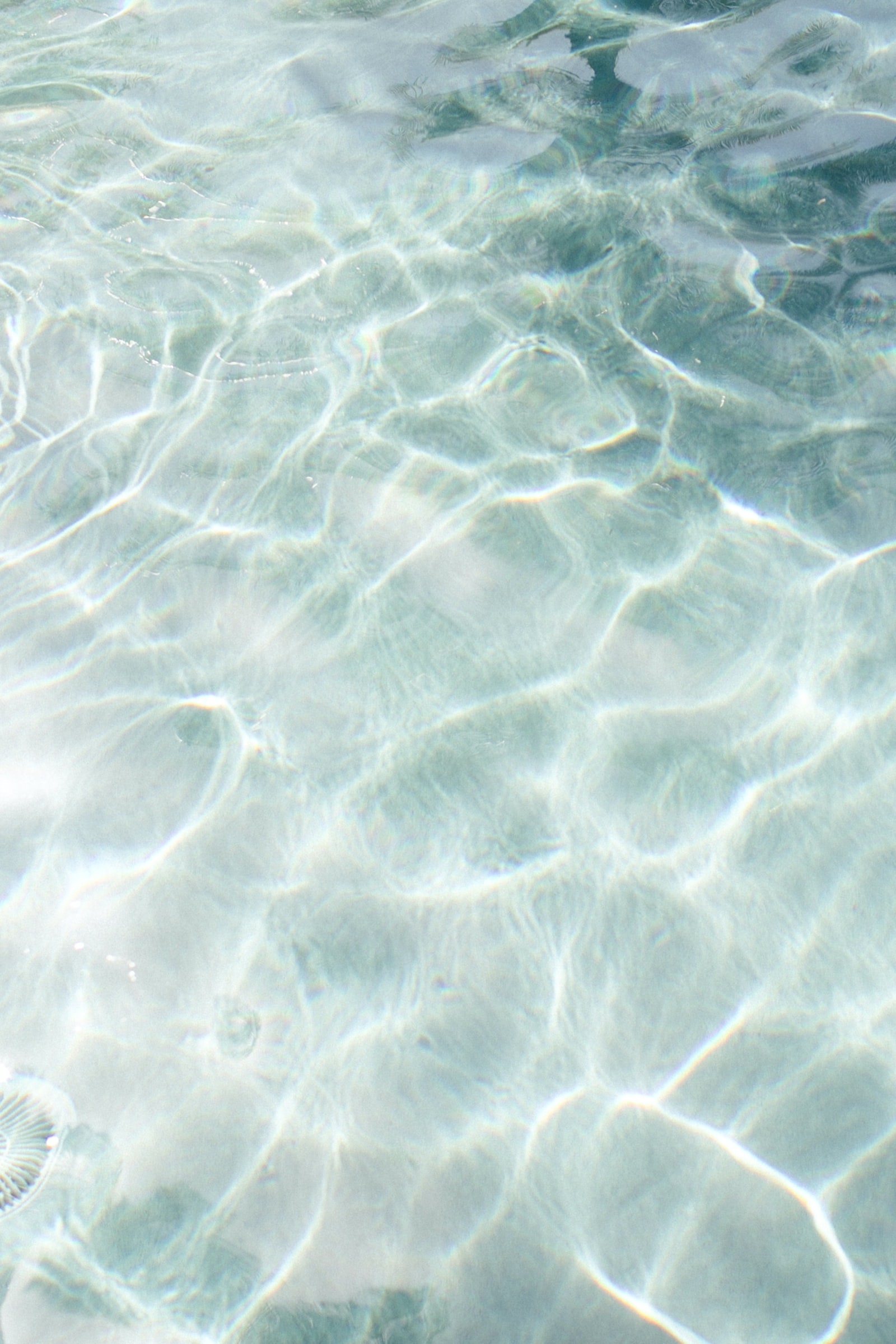 Shot of shallow crystal blue water in the sun