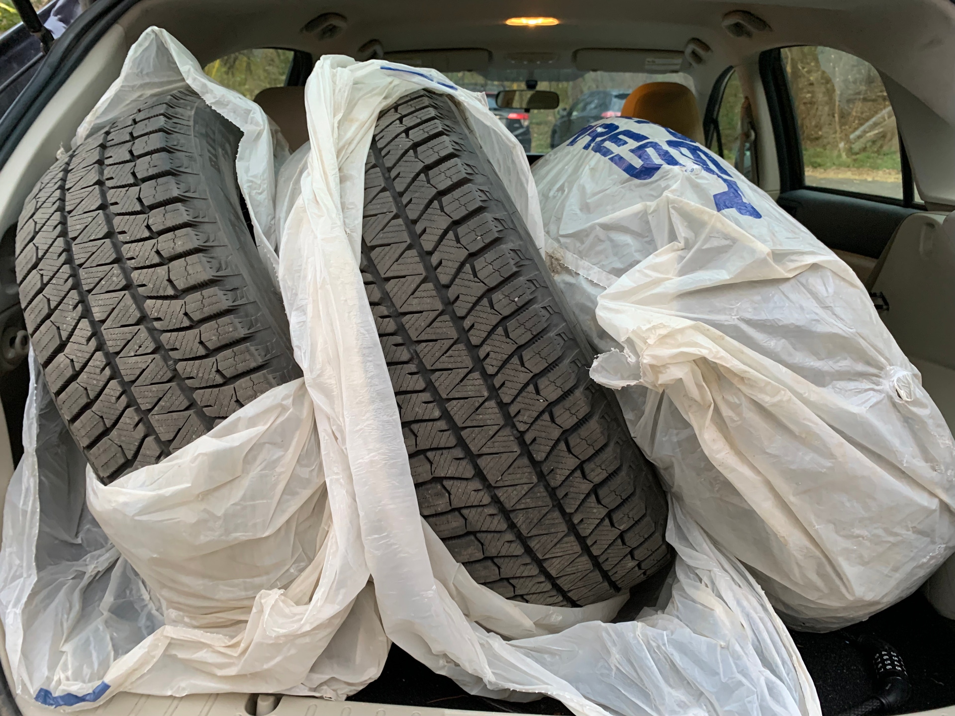 Tires in the back of a car.