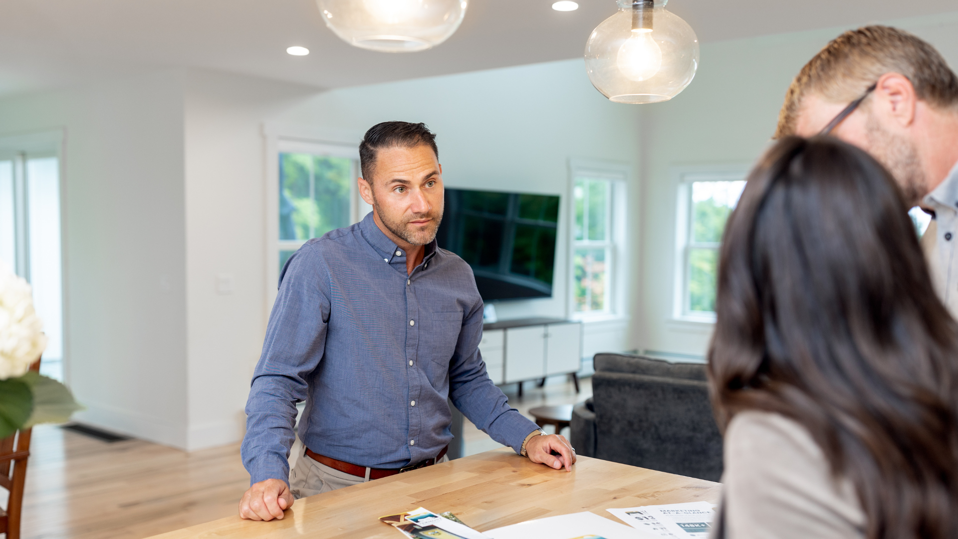A real estate agent talking to two clients.