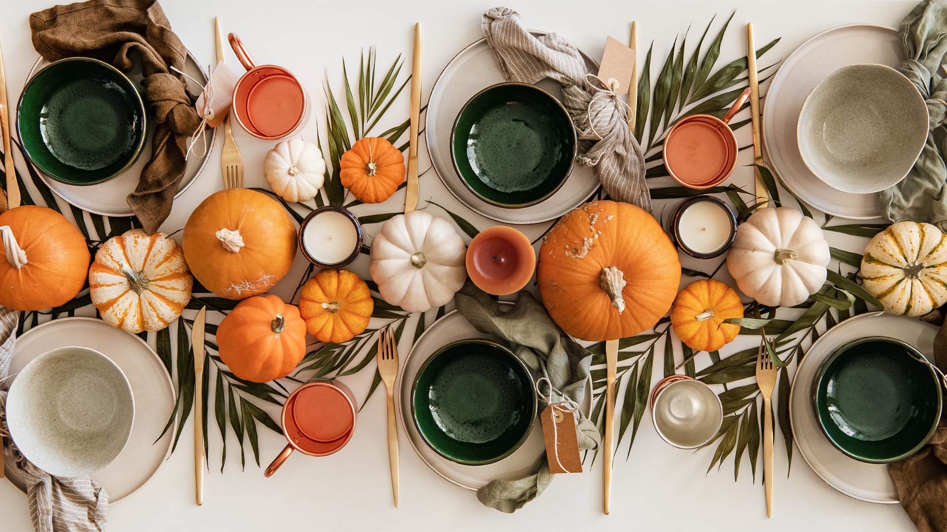 A Thanksgiving tablescape filled with gourds and pumpkins.