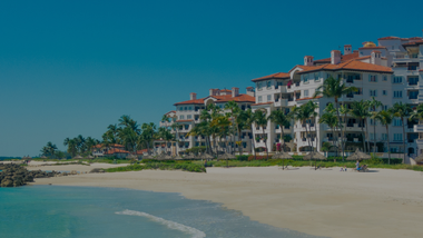 What August 3, 2026 Condo Lender Rules Mean for Treasure Island & Pinellas Beach Sellers High-angle view of beachfront condominium towers along Gulf Boulevard in Treasure Island, Florida.