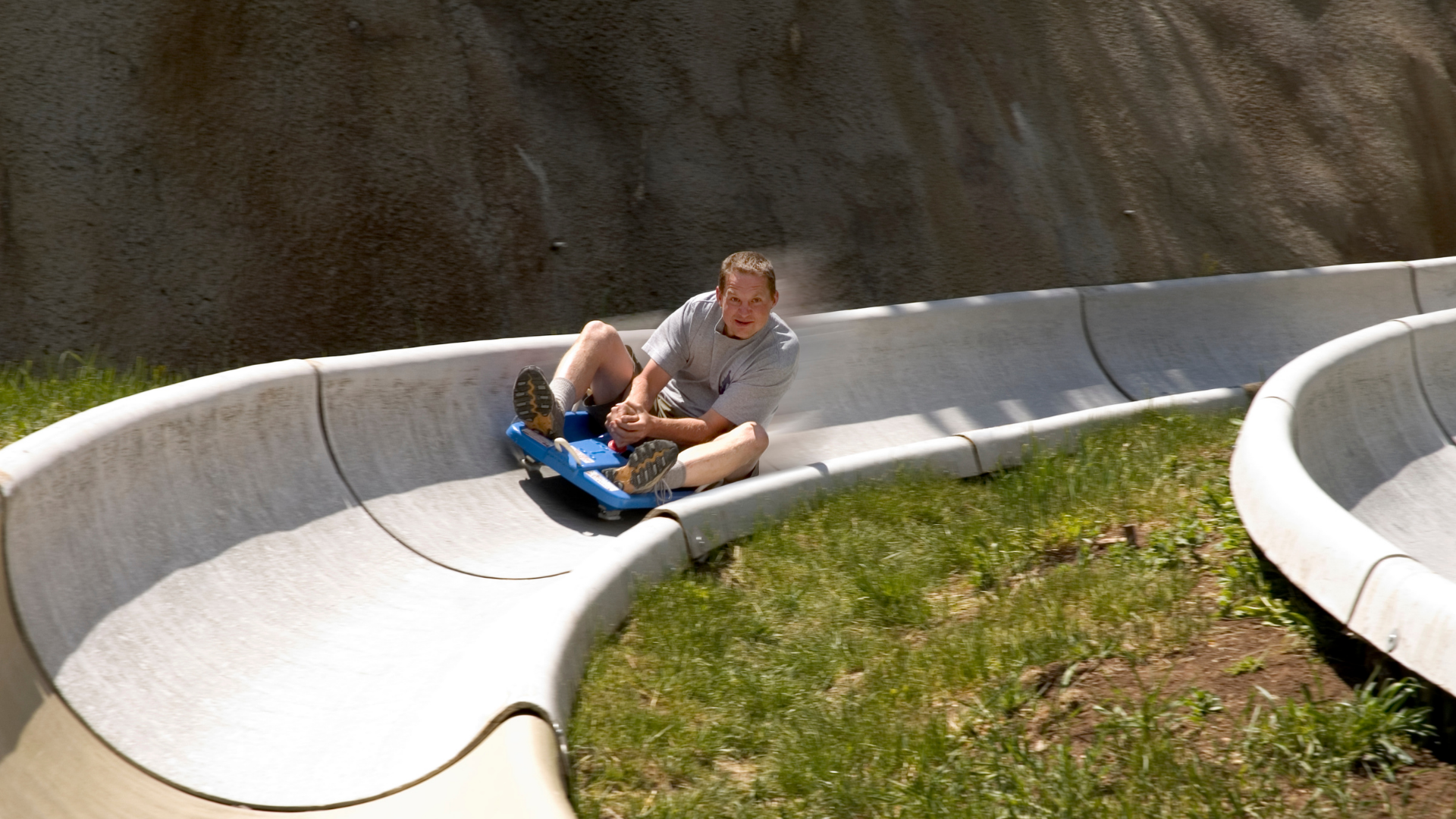 A man riding an alpine slide