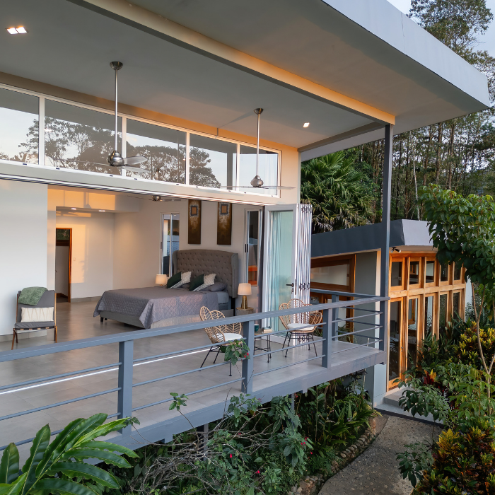 Bedroom with glass walls and terrace in Pérez Zeledón villa
