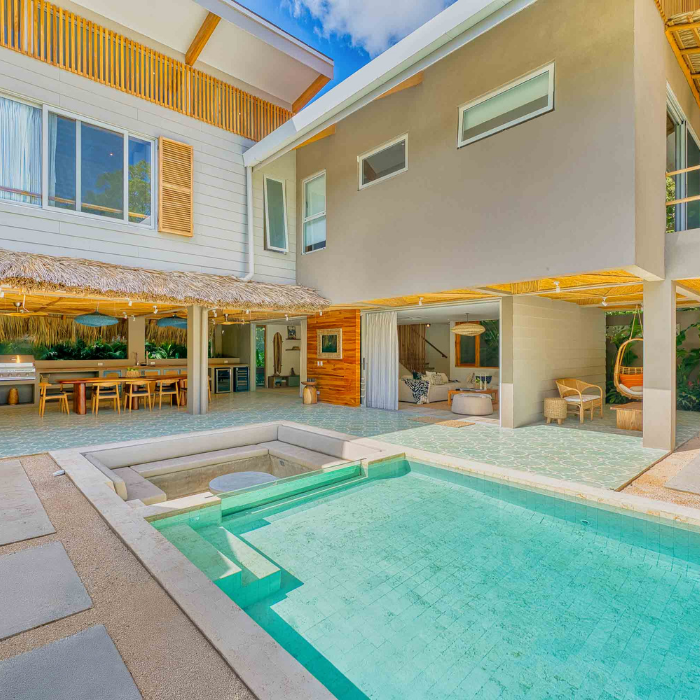 Contemporary tropical home in Tamarindo featuring an open-concept design with pool, outdoor dining area, and modern finishes.