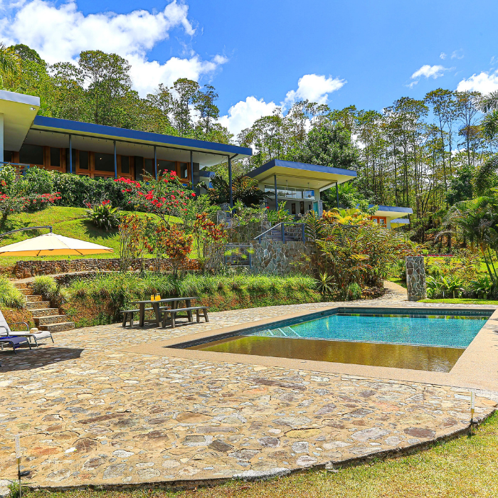 Stone terrace with swimming pool and gardens in a Pérez Zeledón luxury home