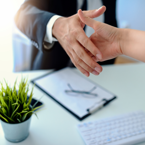 Business handshake during a real estate transaction meeting
