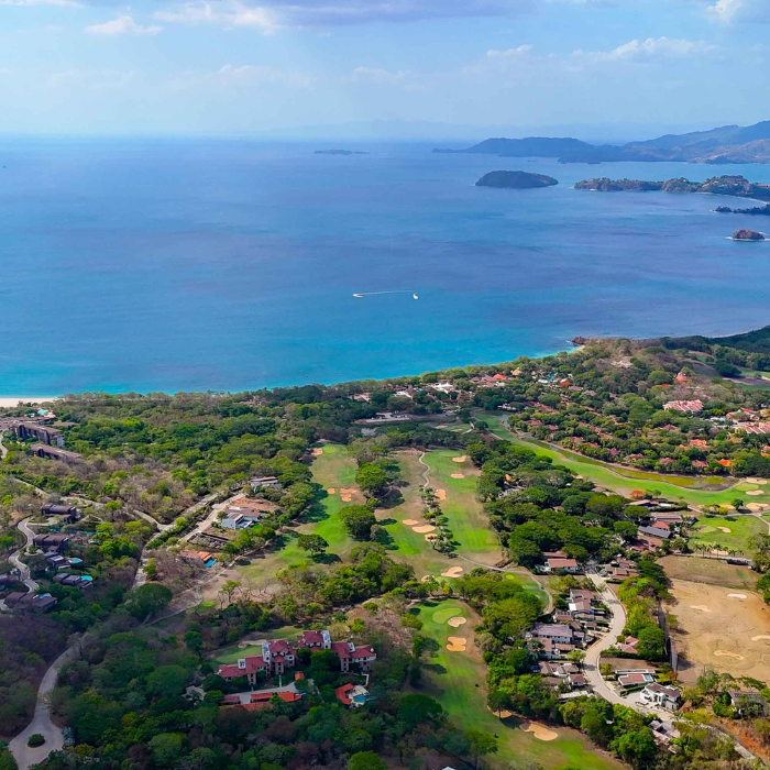Aerial view of A golf course community with oceanfront marina lifestyle, island archipelago