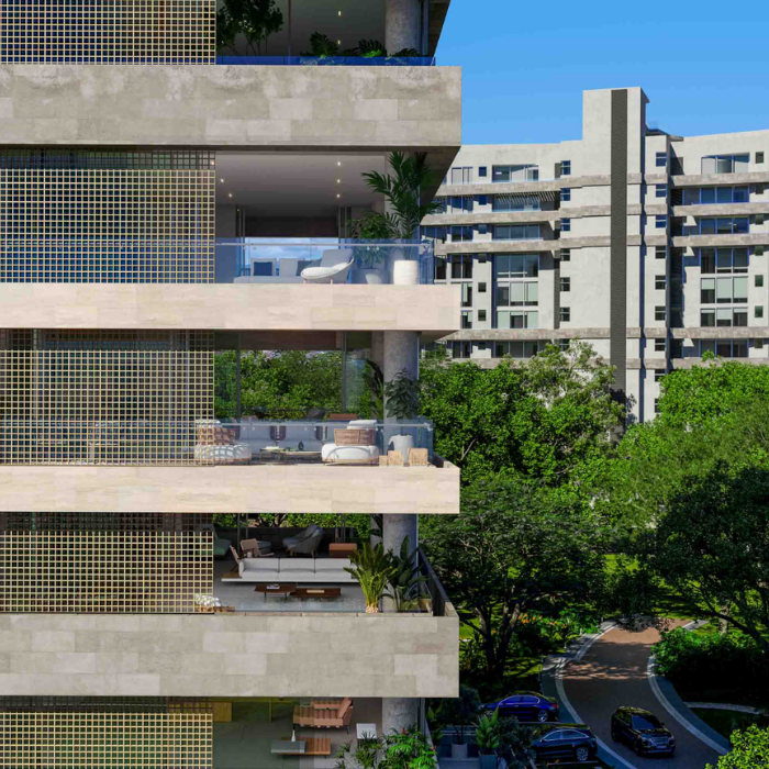 Tropical condominium community with lush landscaping, modern residential buildings, and parked vehicles in Costa Rica.